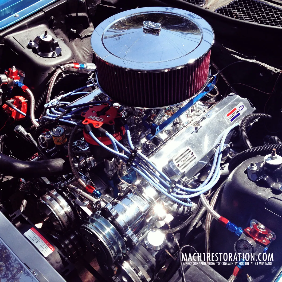 The finished small block V8 with a chrome air cleaner and polished intake in the Mach 1 engine bay