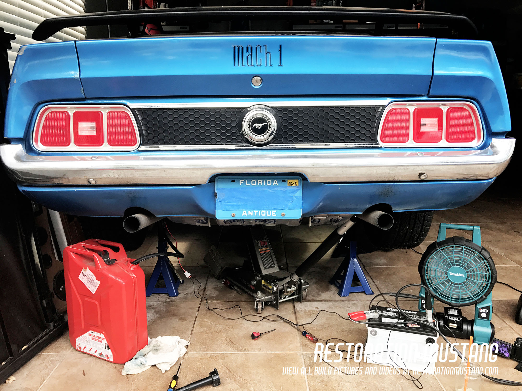 Showing the back of the Mustang prior to removal of the gas tank. Fuel pump drain in place